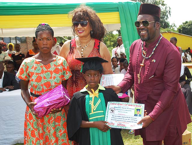 The child receives a graduation certificate from Child Africa